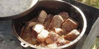Beef roast simmering in a dutch oven
