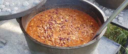 Signature chuckwagon beans sitting in Dutch oven