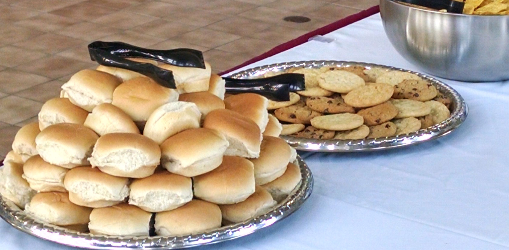 Assortment of dinner rolls, cookies and other delicious food