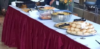 Traditional catering food assortment arranged on table with beautiful red cloth